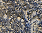 The floor of Candor Chasma in central Valles Marineris, with giant jumbled blocks of bright layered sediments, accentuated by dark-toned sand in the low areas between blocks. The floor of Candor Chasma in central Valles Marineris presents an amazing scene: giant jumbled blocks of bright layered sediments, accentuated by dark-toned sand in the low areas between blocks. This could be a giant landslide deposit, which might have formed when a deep lake was breached and giant floods carved channels far to the east and north of this region.